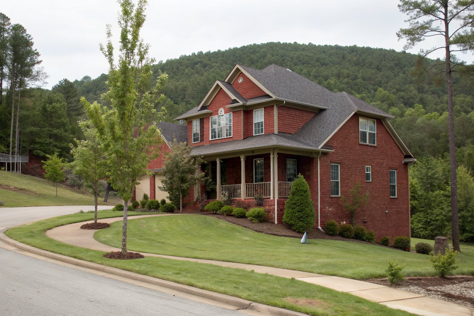Two-story red brick home with a covered porch on a curved cul-de-sac